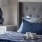 a bed with a lamp and a tray of food on it