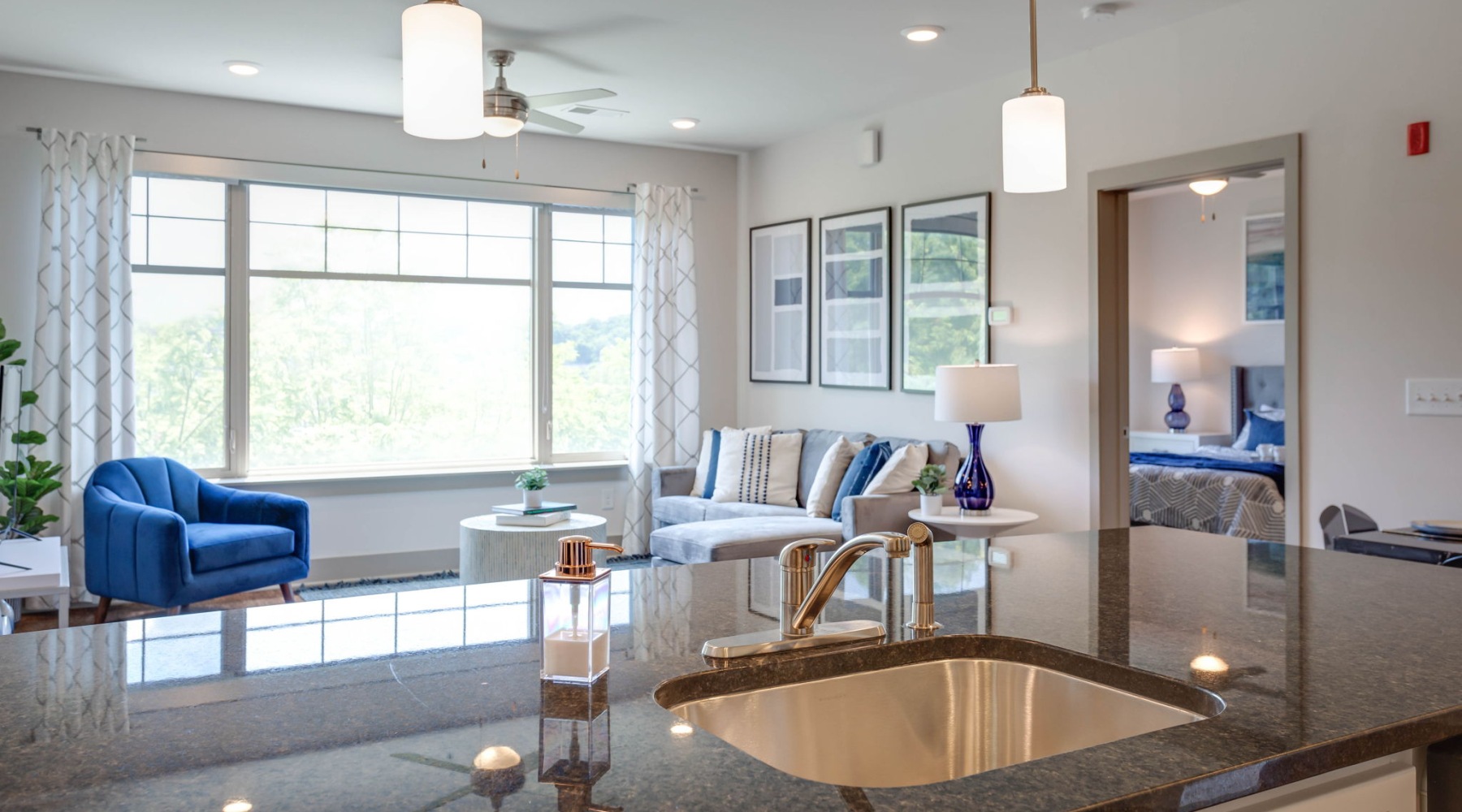Live Beautifully living room connected to kitchen