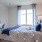 a bedroom with a bed and a chair