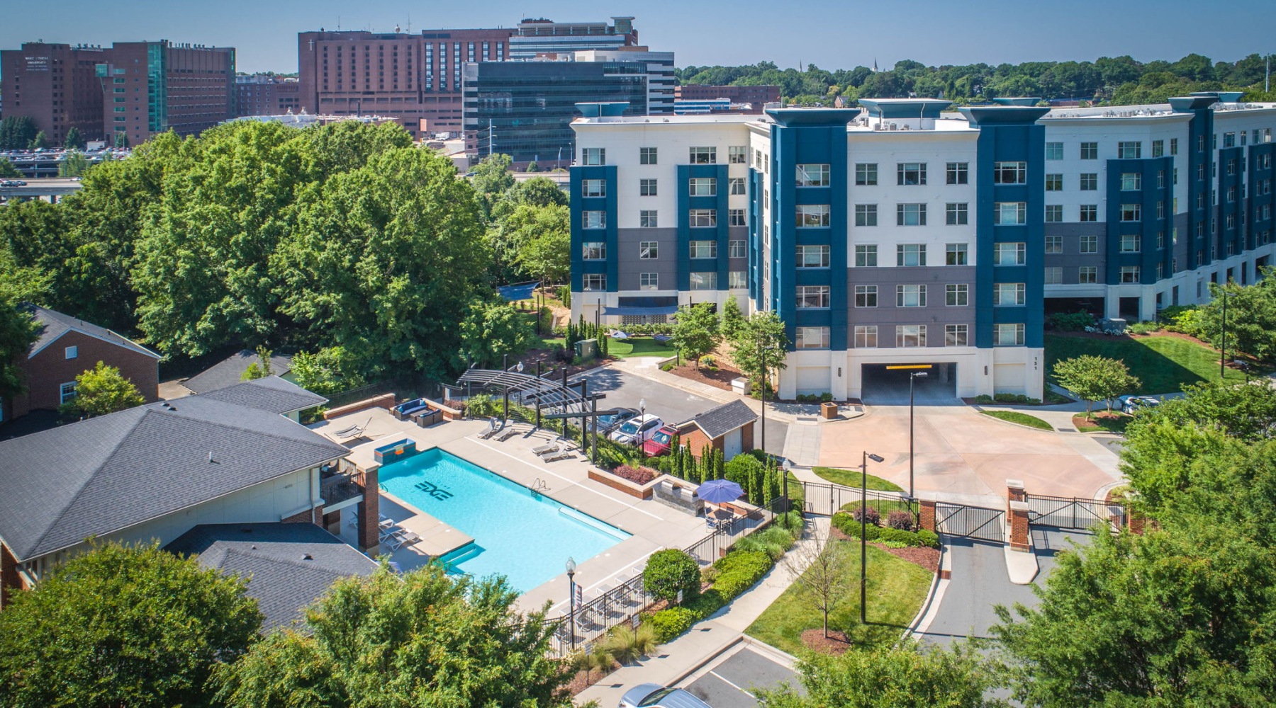 Live Beautifully pool with spacious areas and lush landscaping