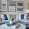 a couch with a table and a lamp in a room with pictures on the wall