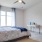a bedroom with a bed and a fan