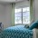 a bedroom with a bed and a desk